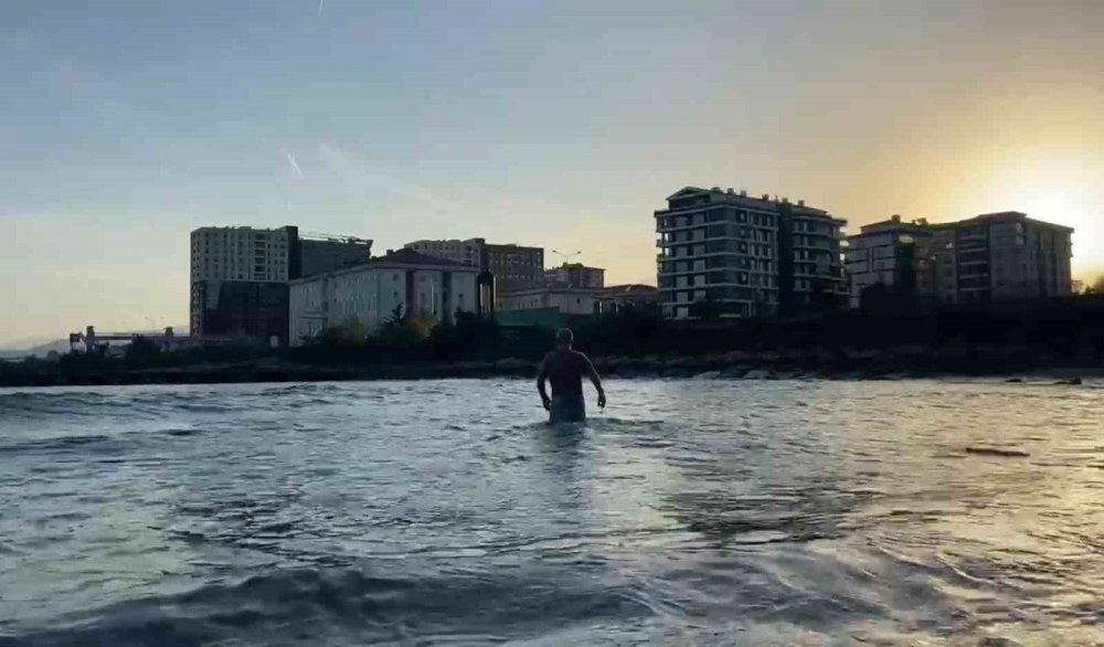 RİZE'NİN PAZAR İLÇESİNDE HAVALARIN SOĞUMASINA ALDIRMAYAN BİR AHMET MAMİN "DENİZ SICAK" DİYEREK KENDİNİ KARADENİZ'İN DALGALI SULARINA BIRAKTI